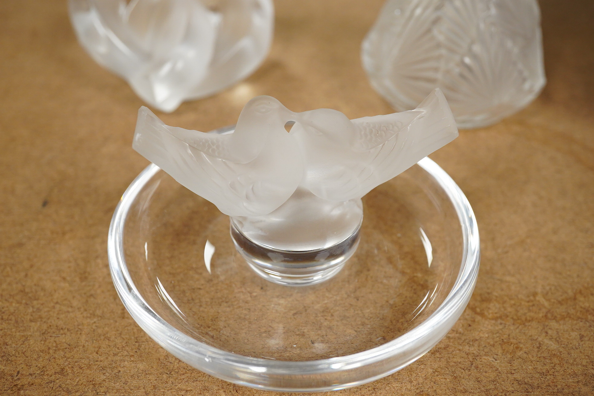 A Lalique scent bottle with stopper, a Lalique lovebirds pin-dish and and a Lalique heart-shape knot, scent bottle 12cm
